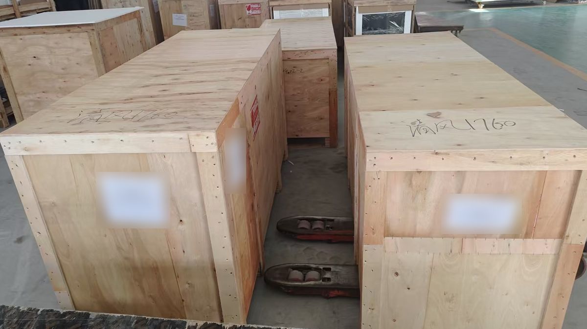 Two wooden crates, one for the cabinet and one for the glass tank, ready to ship